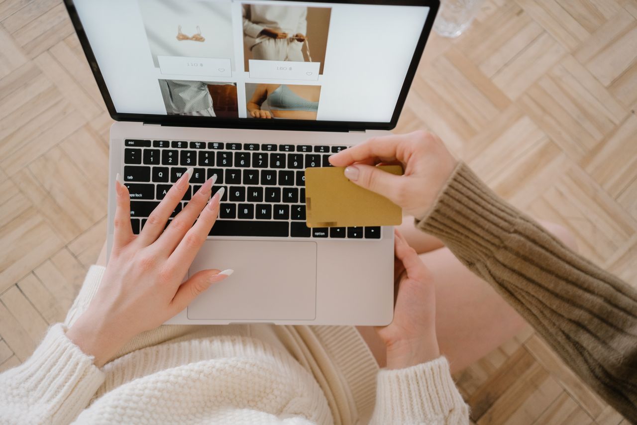 about-02 Person shopping online using a laptop and credit card, highlighting e-commerce convenience.